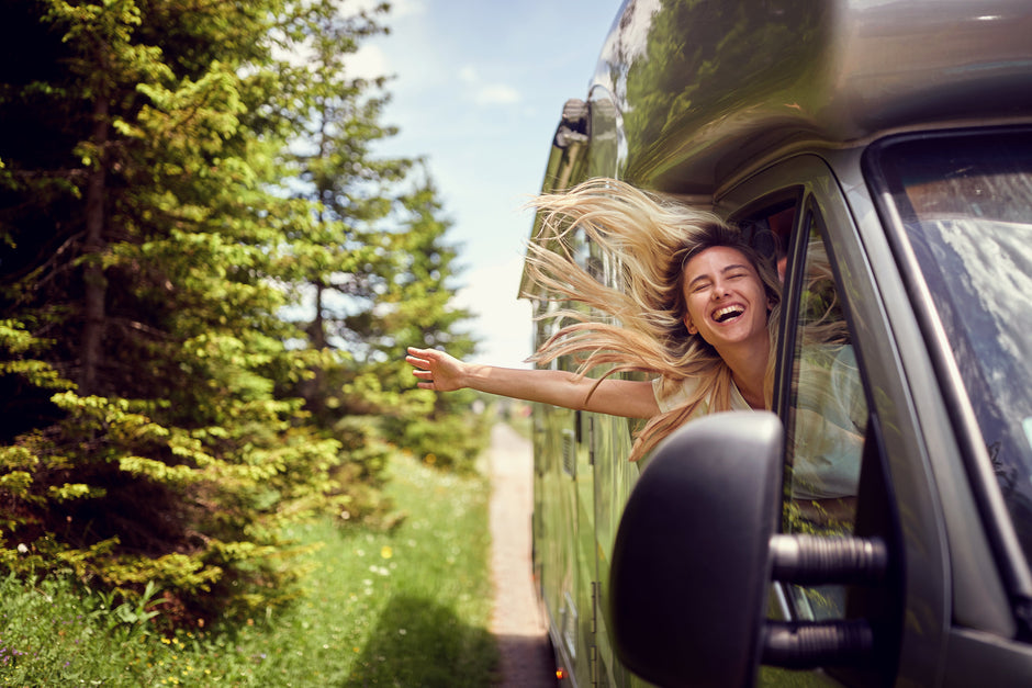 Gift Ideas for Living in a Van or RV a woman is hanging out of the window of a car