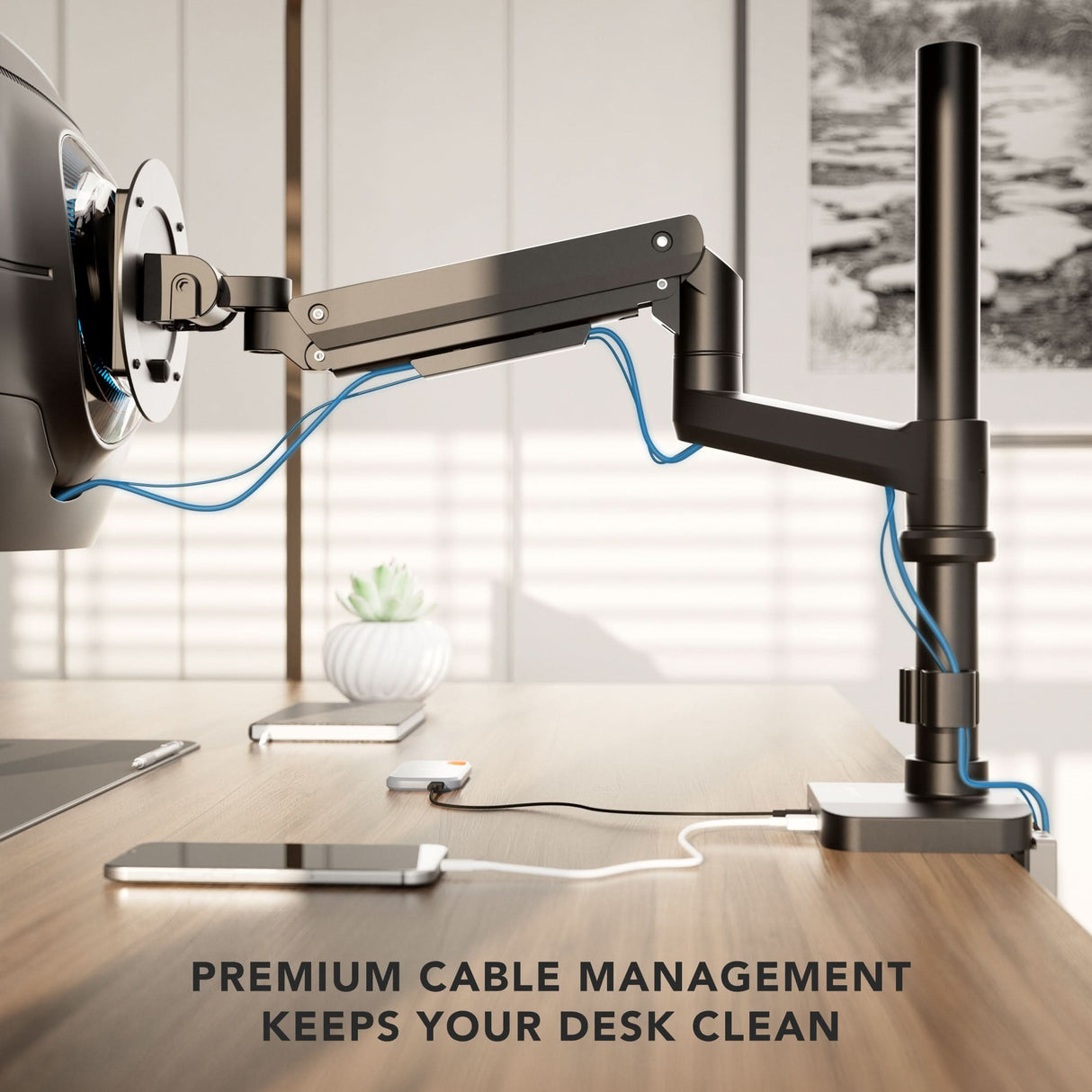A Mount-It! Heavy-Duty Monitor Mount with Pole & Gas Spring Arm organizes blue cables along its adjustable arm on a tidy desk with a phone and plant. Text: PREMIUM CABLE MANAGEMENT KEEPS YOUR DESK CLEAN.