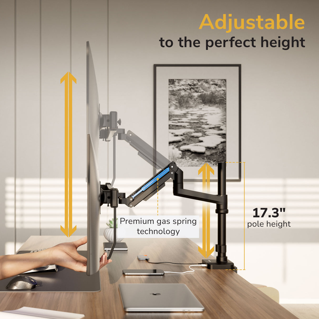A modern office showcases the Mount-It! Dual Monitor Mount with Pole and Crossbar offering 17.3 inches of height adjustment via premium gas spring tech, as a hand lifts a monitor while laptops sit on the desk.