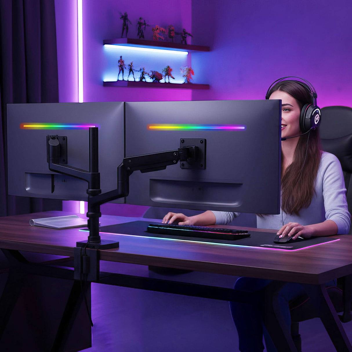 A woman in headphones sits at a desk using the Mount-It! Heavy-Duty Dual Stacking Monitor Mount with Pole & Gas Spring Arms, surrounded by colorful LED lights. Shelves with action figures and neon accents create a modern, gaming-inspired workspace.