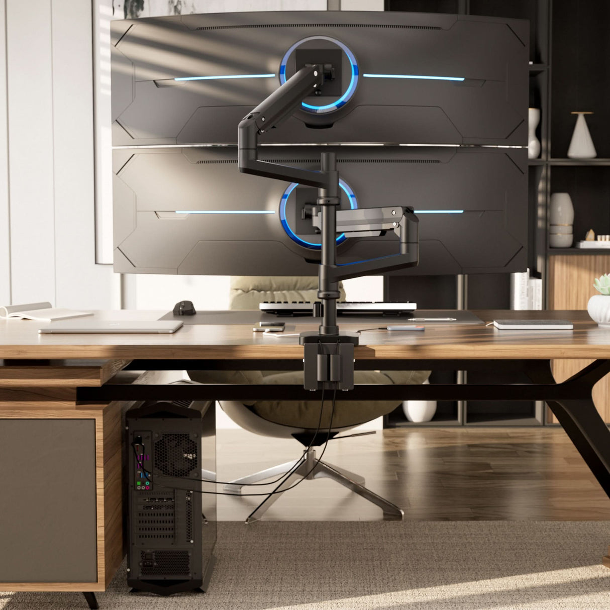 A modern office desk setup highlights the Mount-It! Heavy-Duty Dual Stacking Monitor Mount with Pole & Gas Spring Arms, vertically supporting two large curved monitors for a sleek workspace, with a desktop tower and stylish shelves in the background.