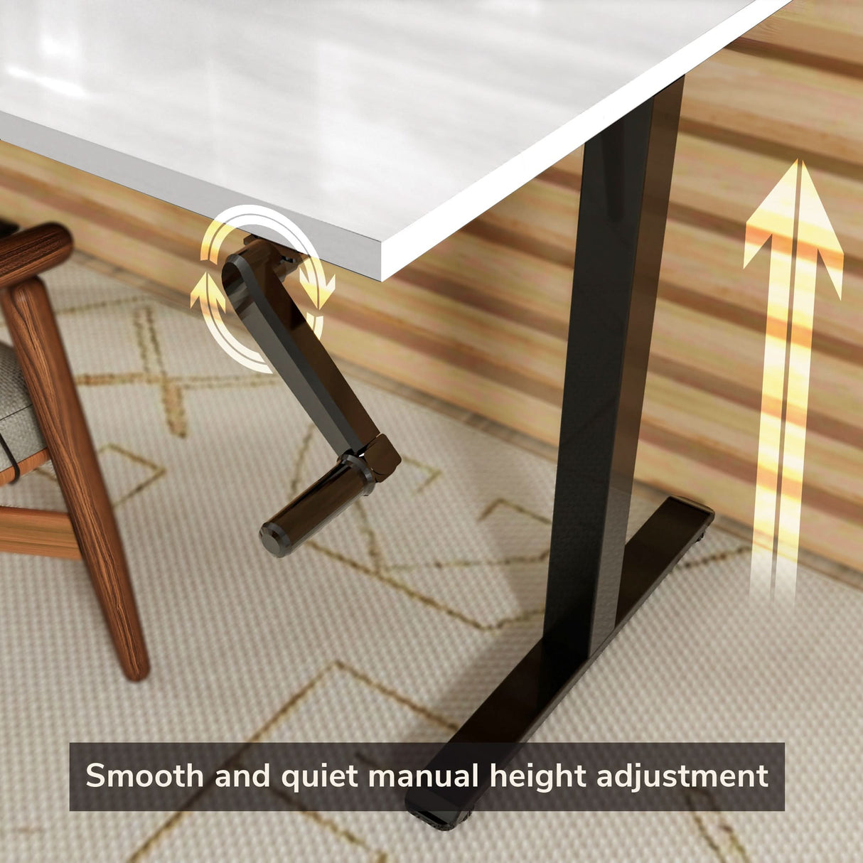 A close-up of the Mount-It! Hand Crank Standing Desk Frame with 48" Tabletop, featuring a black manual crank handle for smooth, quiet height adjustment next to a chair. Yellow arrows show upward movement.