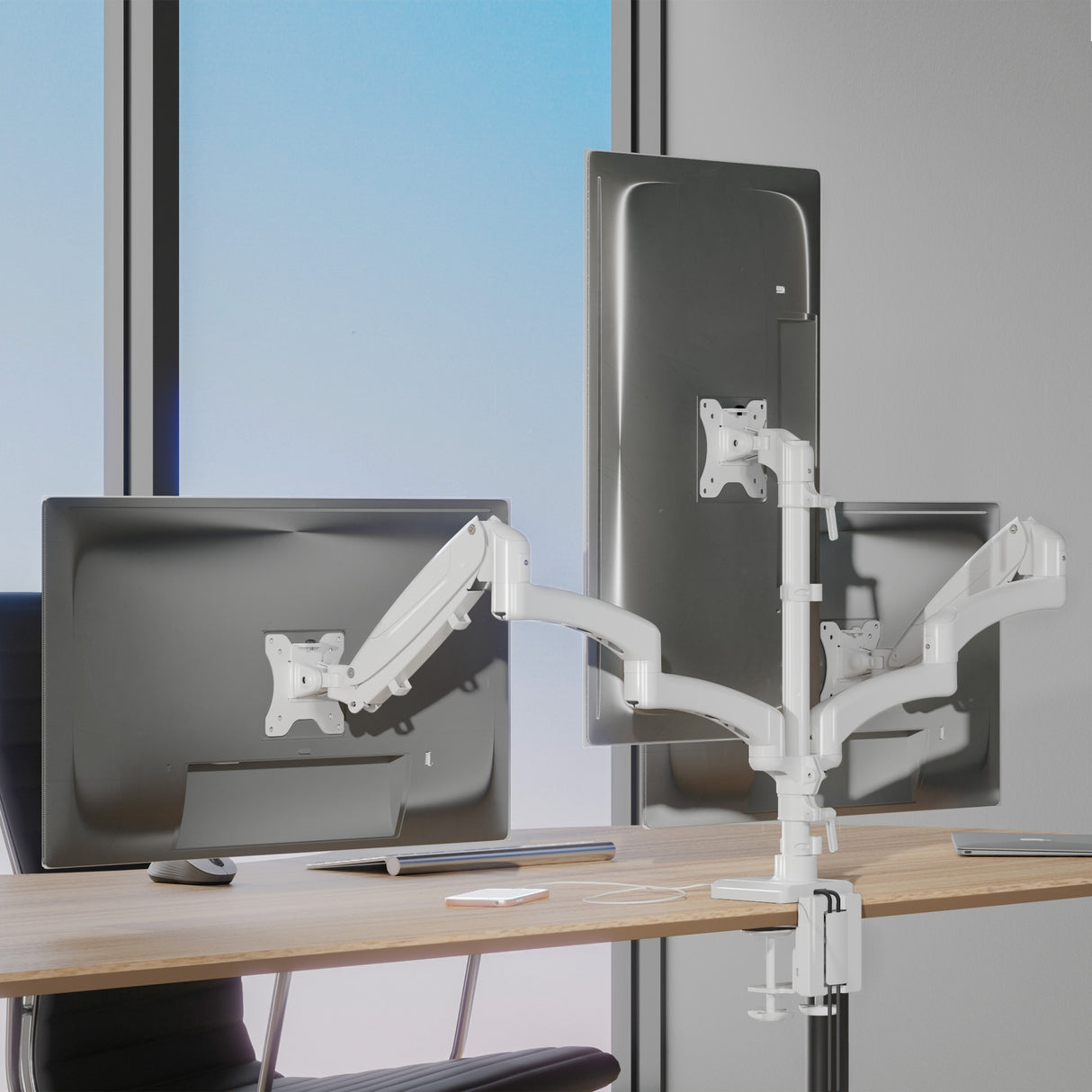Triple Monitor Mount with Gas Spring Arms and USB Ports Triple Monitor Mount with Gas Spring Arms and USB Ports mounted on a desk, showcasing three adjustable screens held by white aluminum arms with gas spring mechanism, allowing tilt, swivel, and rotation for ergonomic positioning, with a clean workspace and natural light in the background, designed for productivity enhancement in professional or creative environments.