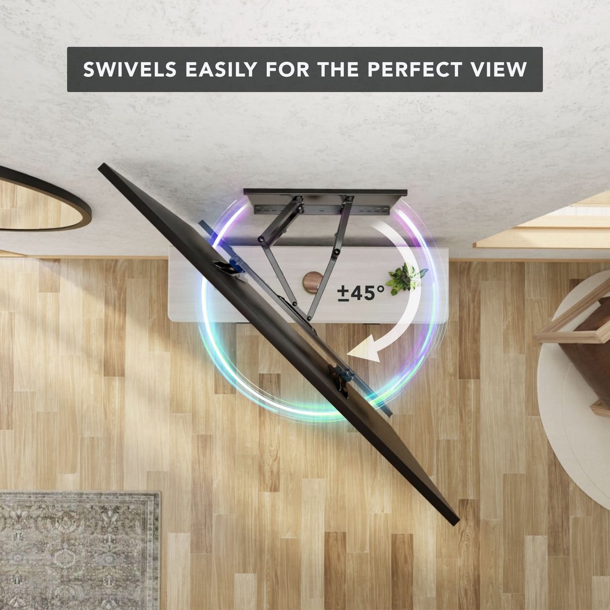 Heavy Duty Full Motion TV Wall Mount with Extension shown from above mounted on the ceiling, demonstrating its ability to swivel up to 45 degrees for optimal viewing angles in a modern room with wood flooring and minimal furniture, highlighting its sturdy dual arm design and full motion capability.