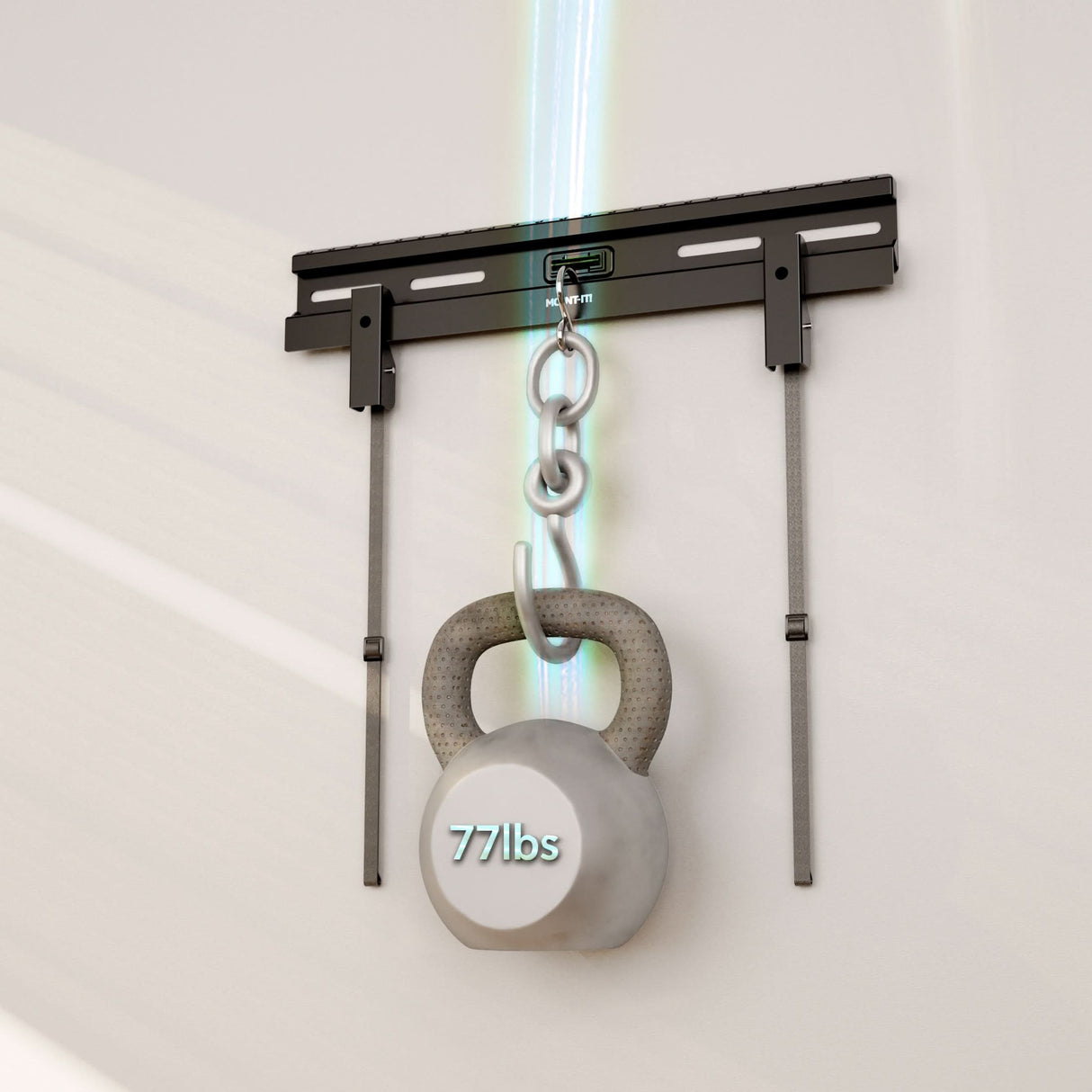 A gray 77-pound kettlebell hangs from a chain attached to the Mount-It! No Stud TV Wall Mount for TVs 23"–65", which features two vertical supports on a light-colored wall, with blue light highlighting the secure and easy installation.