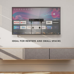 No Stud TV Wall Mount for TVs 23" - 65" installed on a clean wall above a modern floating cabinet in a minimalist room, demonstrating a low-profile, flexible, damage-free mounting solution ideal for renters and small spaces, supporting a large flat-screen TV with streaming apps visible on the screen, emphasizing simplicity and strength without drilling or stud access. No Stud TV Wall Mount for TVs 23" - 65" installed on a clean wall above a modern floating cabinet in a minimalist room, demonstrating a low-profile, flexible, damage-free mounting solution ideal for renters and small spaces, supporting a large flat-screen TV with streaming apps visible on the screen, emphasizing simplicity and strength without drilling or stud access.