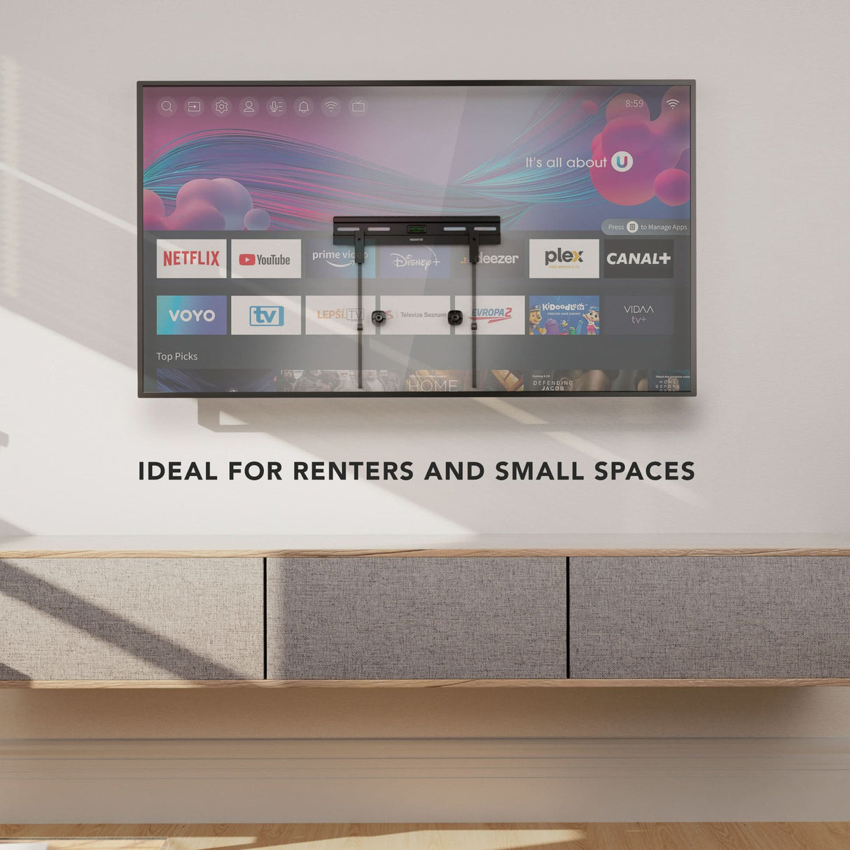 No Stud TV Wall Mount for TVs 23" - 65" installed on a clean wall above a modern floating cabinet in a minimalist room, demonstrating a low-profile, flexible, damage-free mounting solution ideal for renters and small spaces, supporting a large flat-screen TV with streaming apps visible on the screen, emphasizing simplicity and strength without drilling or stud access.