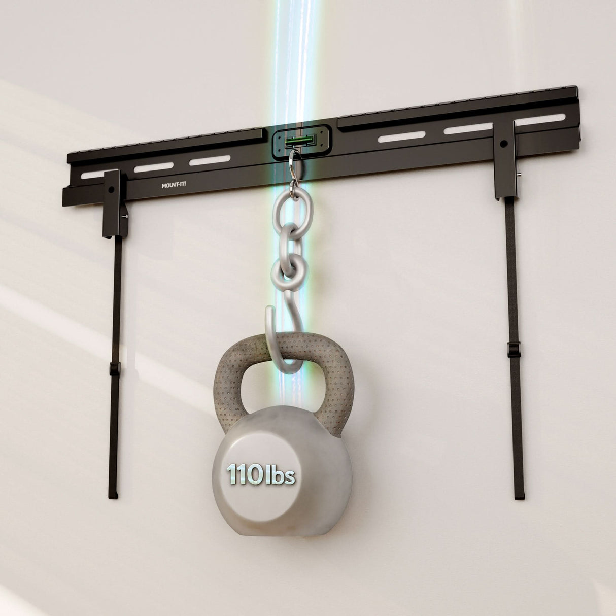 A 110 lb gray kettlebell hangs from a metal wall bracket with a chain, showcasing the strength of the Mount-It! No Stud TV Wall Mount—impressive, like what’s needed for heavy-duty mounting solutions.