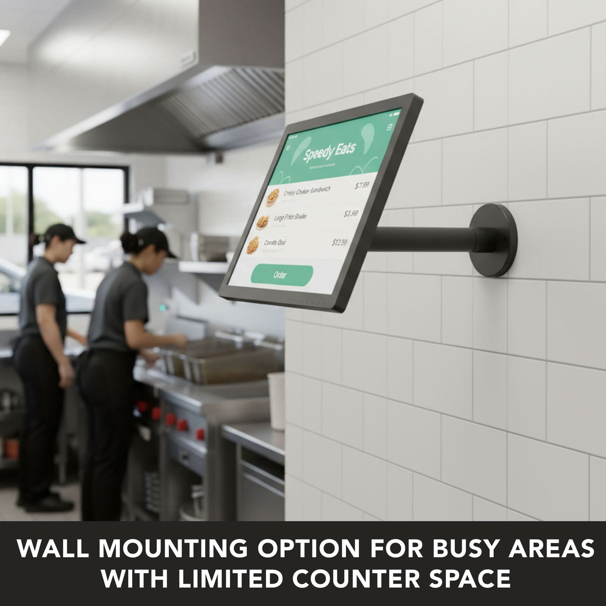 A Mount-It! Point-of-Sale Monitor Stand is wall-mounted in a commercial kitchen, displaying a menu, while two kitchen staff work nearby. Text reads: THE PERFECT SPACE-SAVING POS SOLUTION FOR BUSY COMMERCIAL KITCHENS.