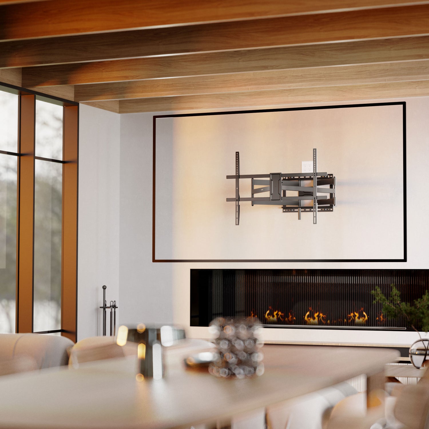 Full Motion TV Wall Mount with Extra Long Extension for 43" - 100" TVs installed on a modern living room wall above a fireplace, showcasing the heavy-duty steel dual arm design that allows for 42.5" extension, swivel, and tilt adjustments, providing flexible viewing angles while maintaining a sleek, retractable profile ideal for medium to extra-large TVs.