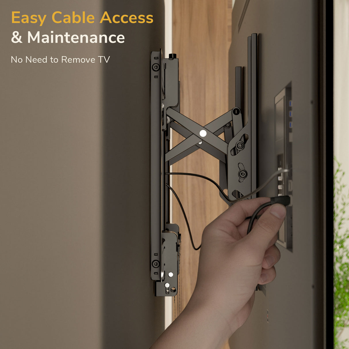 A hand plugs a cable into the back of a TV mounted with the Mount-It! Heavy-Duty Advanced Tilt TV Wall Mount, with text: Easy Cable Access & Maintenance. No Need to Remove TV.