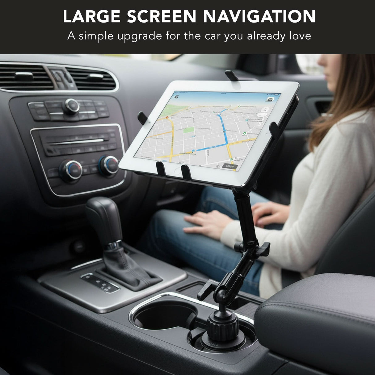 A person in a car uses the Mount-It! Heavy-Duty Cup Holder Tablet ELD Mount to display navigation. Text above: “Large Screen Navigation. A simple upgrade for the car you already love.”.