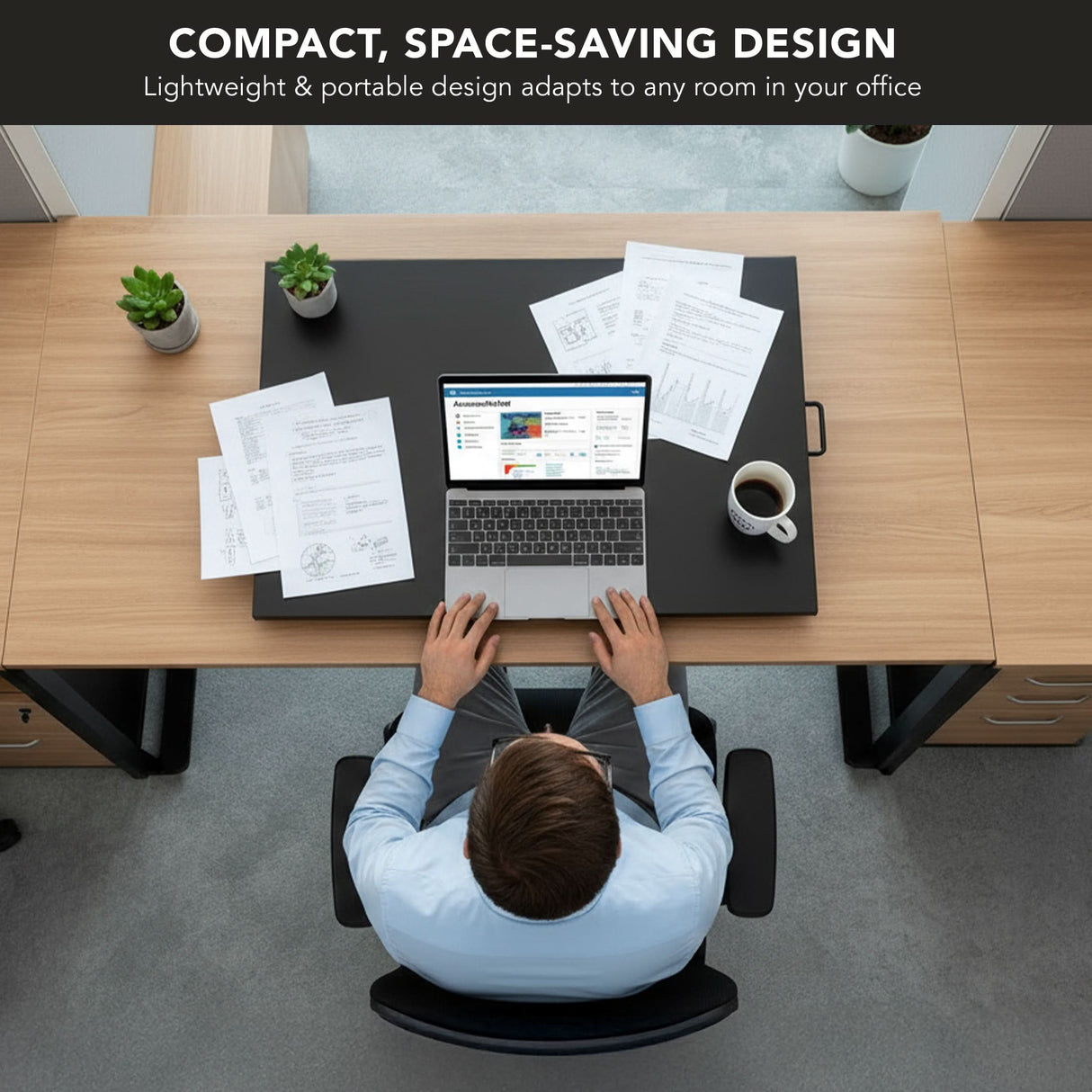 A person works on a laptop at a tidy office, using the Mount-It! Height Adjustable X-Lift Standing Desk Converter. The ergonomic, modern light wood workspace is equipped for comfort and productivity, with papers, a smartphone, and coffee nearby.