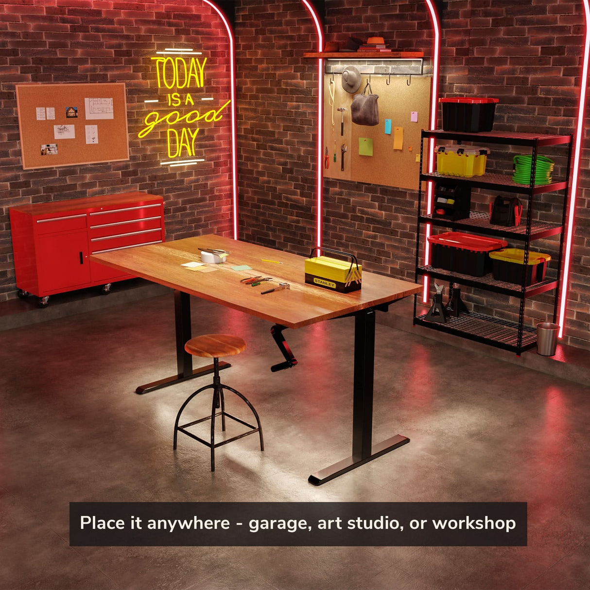 A tidy workshop with a wooden workbench, stool, red tool chest, shelves of bins, cork boards, and a neon TODAY IS A GOOD DAY sign. Place the Mount-It! Standing Desk Frame with Hand Crank anywhere: garage, art studio, or beside your desk.