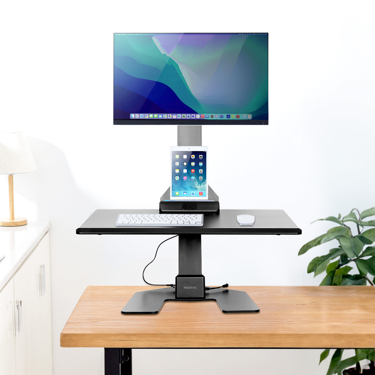 Electric Standing Desk Converter for 1 Monitor Adjustable standing desk converter with computer monitor and tablet on a wood desk and white background