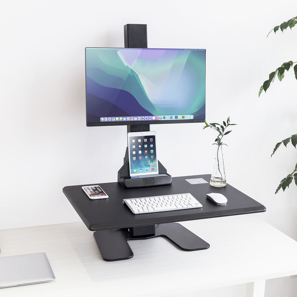 Electric Standing Desk Converter for 1 Monitor Black adjustable desk converter with computer monitor, tablet stand, keyboard, and mouse on a white surface.