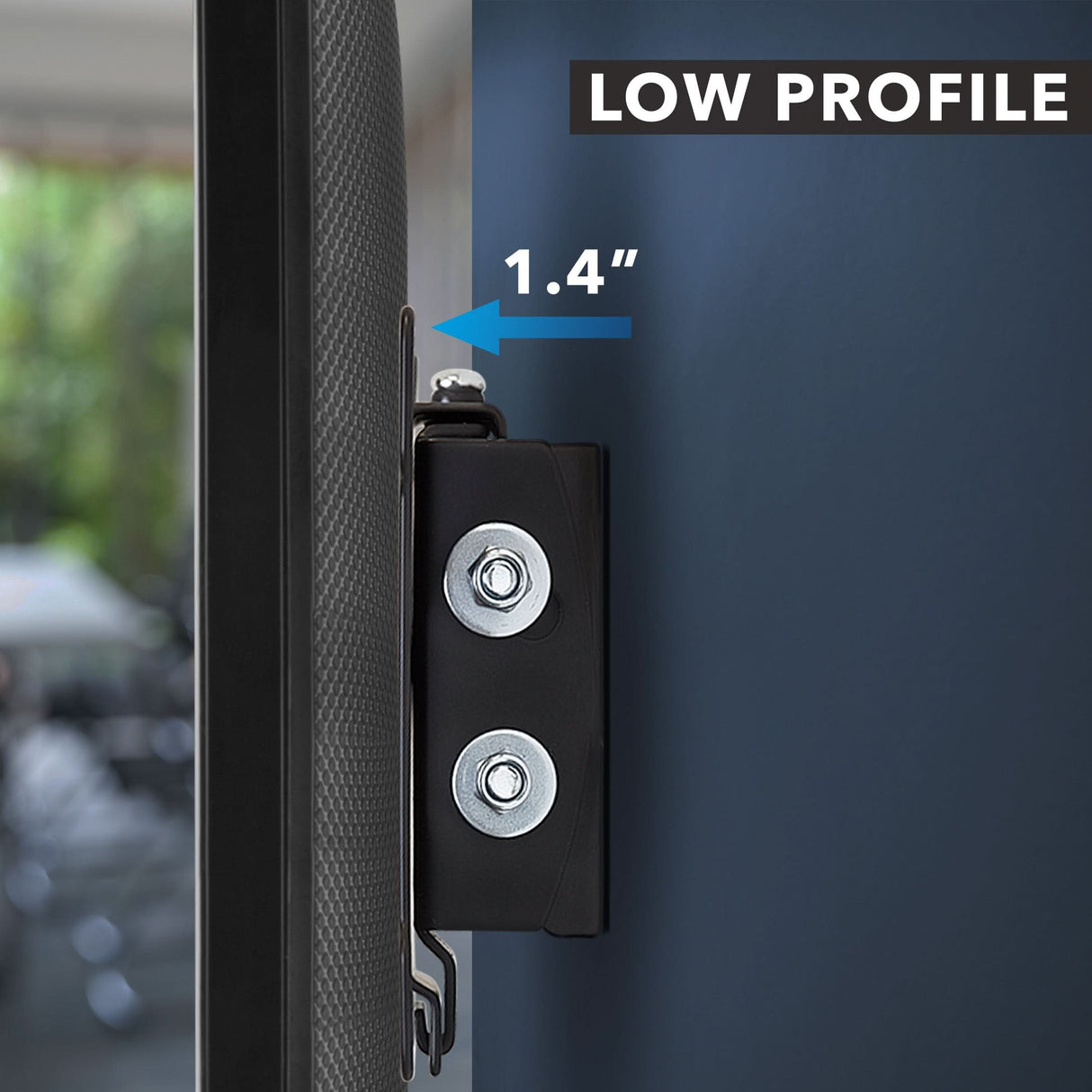 Close-up of the Mount-It! Tilting TV Wall Mount for 32-inch TVs, highlighting its low profile with just a 1.4-inch gap from the wall. A blurred room interior appears in the background.