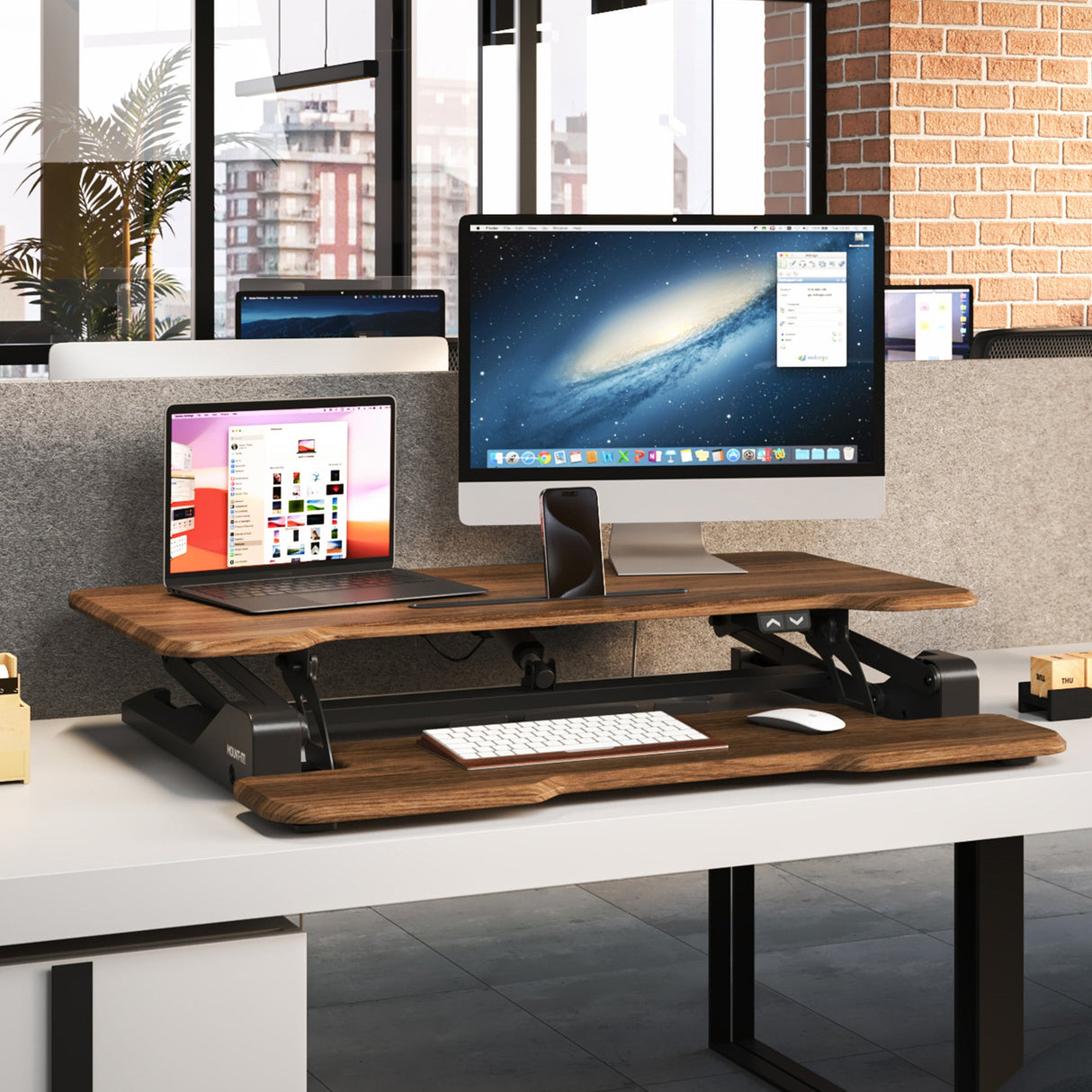 Electric Standing Desk Converter with 38" Desktop Electric Standing Desk Converter with 38" Desktop - MI-8011 - Dark Walnut Woodgrain - In use with Monitor and laptop in an office environment - lowered position