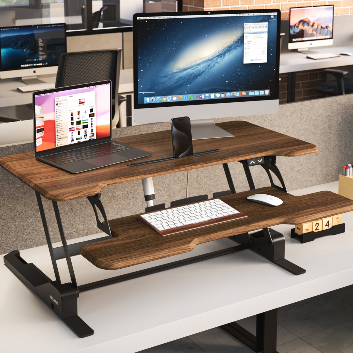 Electric Standing Desk Converter with 38" Desktop - MI-8011 - Dark Walnut Woodgrain - In use with monitor and laptop in an office environment