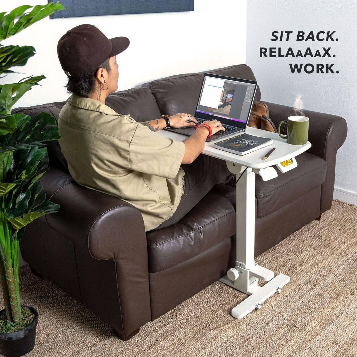 Mobile Standing Desk - Foldable Rolling Overbed Table - MI-8046 with person laying on sofa working on laptop
