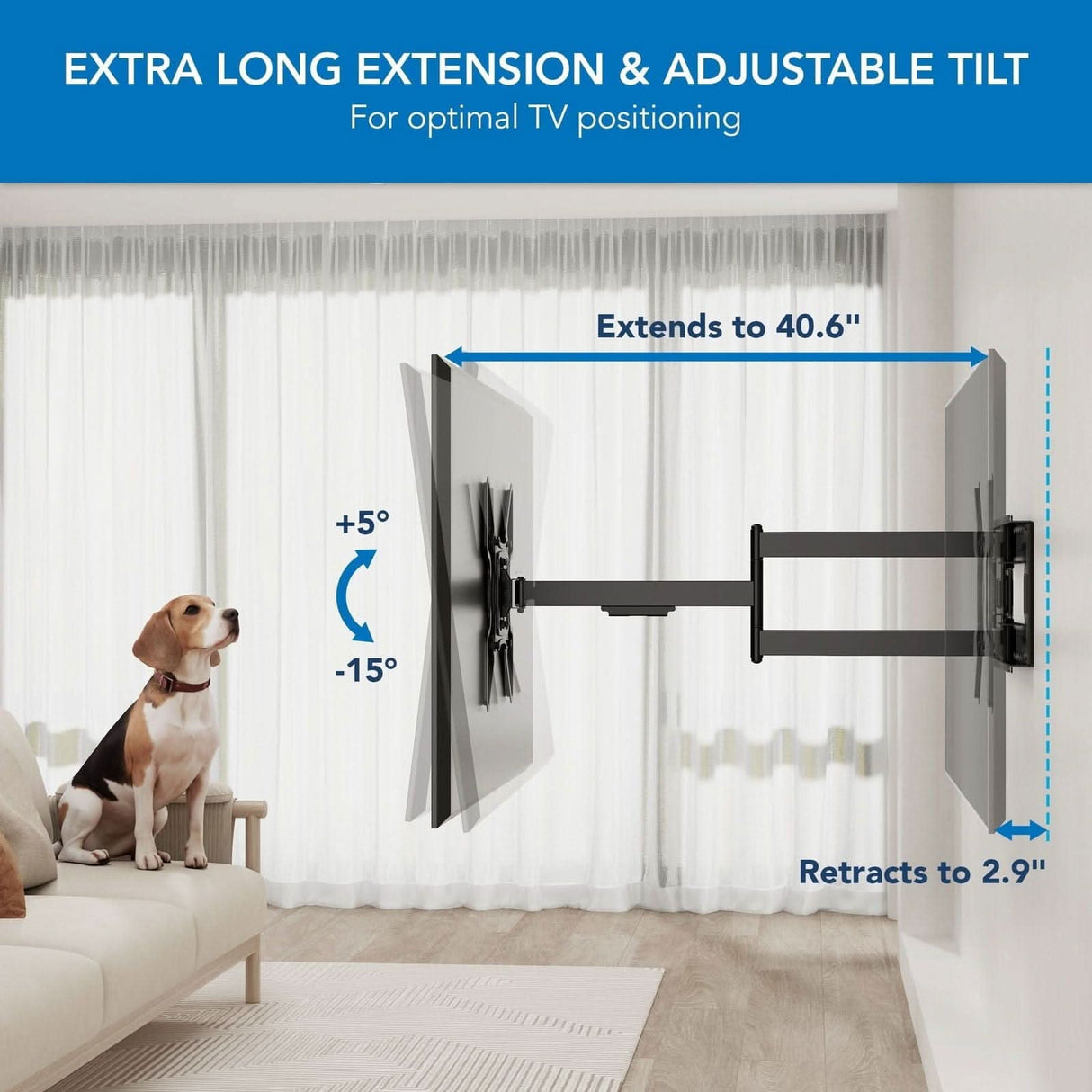 The Mount-It! Full Motion TV Wall Mount with Extra Long Extension extends 40.6" and retracts to 2.9", tilting +5° to -15°. In a bright living room, a dog sits on the couch looking up at the mounted TV.
