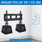 Heavy-Duty Ultra Low Profile TV Wall Mount with Locking Feature shown securely holding two heavy weights to demonstrate its strength and ability to support TVs up to 175 pounds, featuring a sleek black design mounted on a corner wall with a graphic of a flexed arm symbolizing durability and tested to highest safety standards.