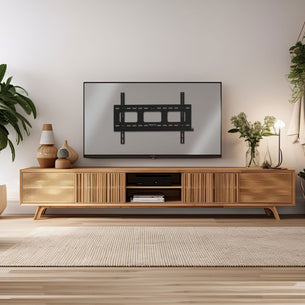 Heavy-Duty Ultra Low Profile TV Wall Mount with Locking Feature displayed on a clean, modern living room wall above a wooden media console, showcasing its sleek design that holds large TVs securely close to the wall with visible mounting brackets, cable management openings, and sturdy construction ideal for both residential and commercial spaces.