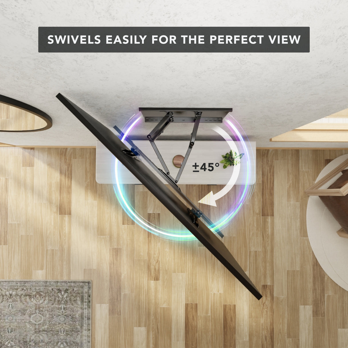 Heavy Duty Full Motion TV Wall Mount with Extension shown from above mounted on the ceiling, demonstrating its ability to swivel up to 45 degrees for optimal viewing angles in a modern room with wood flooring and minimal furniture, highlighting its sturdy dual arm design and full motion capability.