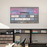 Modern living room setup featuring a large flat-screen TV mounted flush against the wall using the No Stud TV Wall Mount for TVs 37" to 86", showcasing a sleek, stud-free installation on drywall without drilling into studs. The mount supports heavy TVs securely and includes a built-in level for precise alignment, creating a clean, professional look ideal for apartments, studios, or home gyms.