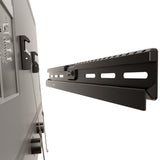 No Stud TV Wall Mount for TVs 37 to 86 inches shown attached to drywall without studs, featuring a slim black metal design with automatic spring lock system and built-in bubble level for easy, precise installation and a sleek, professional finish ideal for mounting large TVs up to 132 lbs in spaces where drilling into wood studs is not possible or preferred.