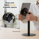Secure your tablet with the Mount-It! Universal Anti-Theft Tablet Countertop Stand, featuring a lock and key. Text: Keep your tablet secure in public spaces. A label highlights the stand’s sturdy, bolt-down base.