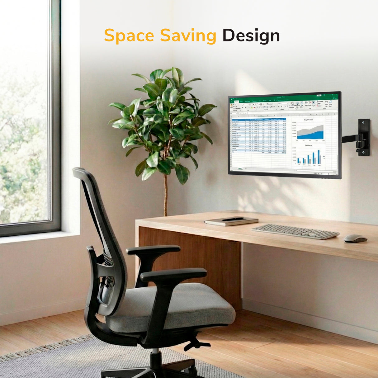 A modern home office features a wooden desk, ergonomic chair, large window, and the Mount-It! Full Motion Display Wall Mount holding a monitor with a spreadsheet. Wireless keyboard, mouse, and potted plant included. Text: "Space Saving Design.