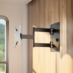 A Mount-It! RV and Trailer TV Wall Mount with Lockable Arm in black is installed on a wooden wall, its adjustable arm extended to hold a flat-screen TV with VESA 200x200 compatibility as natural light fills the room.