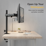 A modern desk with a Mount-It! Full Motion Dual Monitor Desk Mount, keyboard, mouse, lamp, and plant—promoting an organized workspace. Text reads: Open Up Your Workspace. More room for essentials and ergonomic screen positioning.