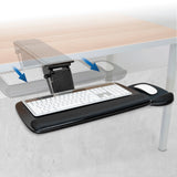 Keyboard tray attached to a desk with a keyboard and mouse on it