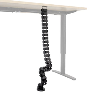 Cable Management Spine shown mounted under a sit-stand desk, with flexible snap-together segments organizing and protecting multiple cables running from the desktop to the floor, providing an adjustable and tidy cable management solution ideal for maintaining a clean workspace.