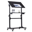 The Mount-It! Mobile Lectern Stand Up Desk is a black, height-adjustable drafting table on wheels with a tilted work surface for papers, a flat shelf with pencil holder and jar, suitable as a podium or desk, shown on a white background.