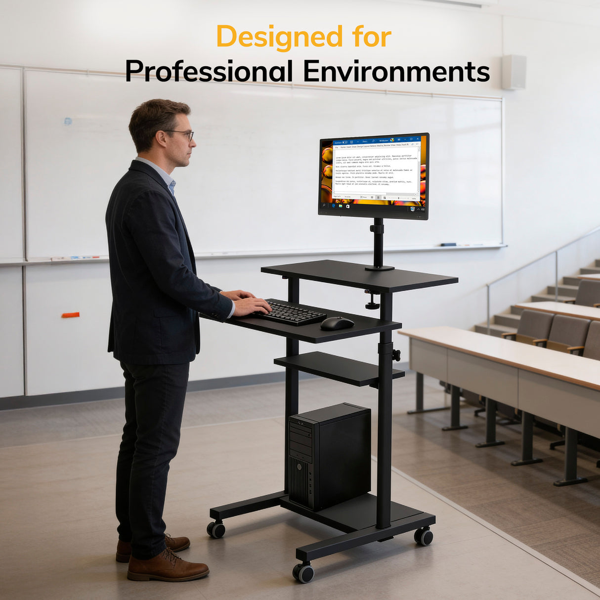 A man in business attire uses the Mount-It! Rolling Computer Work Station with Monitor Mount as a height-adjustable workstation in a modern classroom with tiered seating. Text above reads: Designed for Professional Environments.