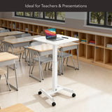 The Mount-It! Height Adjustable Rolling Laptop Desk, shown in a classroom with empty desks and bookshelves, features a white design with laptop and pen on top. Text above reads: Ideal for Teachers & Presentations.