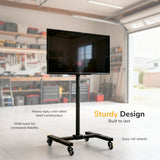 The Mount-It! Adjustable Mobile TV Stand is featured in a garage workshop with a mounted flat-screen TV. Labels show heavy-duty steel, locking casters, and easy-roll wheels. Text: Sturdy Design. Built to last.