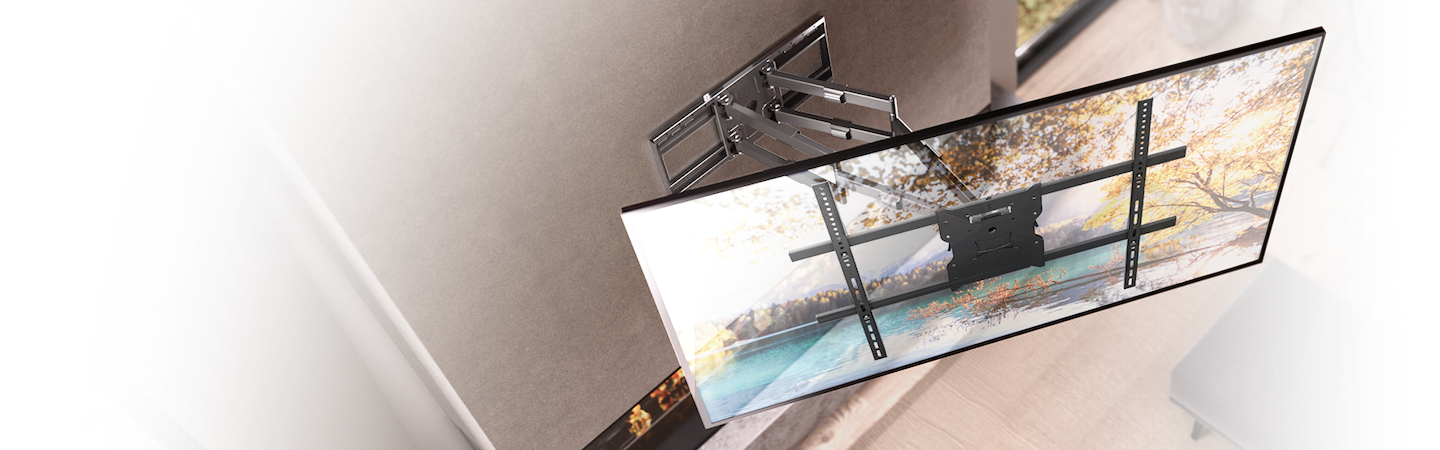 A flat-screen TV mounted on a wall with a full-motion articulating wall mount, showing swivel and tilt functions. The TV displays a scenic landscape with trees and water.